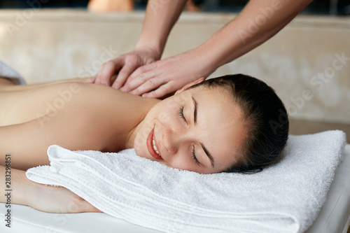 Spa Massage. Beautiful woman relaxing in spa salon. Body care. Spa body. Cosmetology. Girl having massage in the spa salon