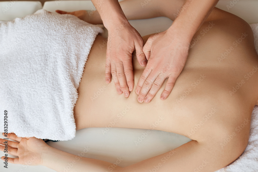 Young woman relaxing with hand massage at beauty spa. Young woman relaxing with hand massage at beauty spa.