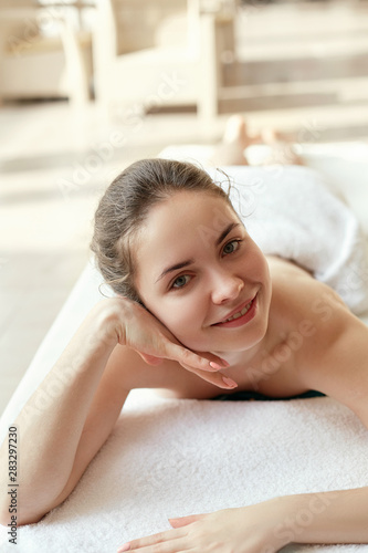 Portrait of young beautiful woman in spa environment. Body care. Spa body. Cosmetology. Massage