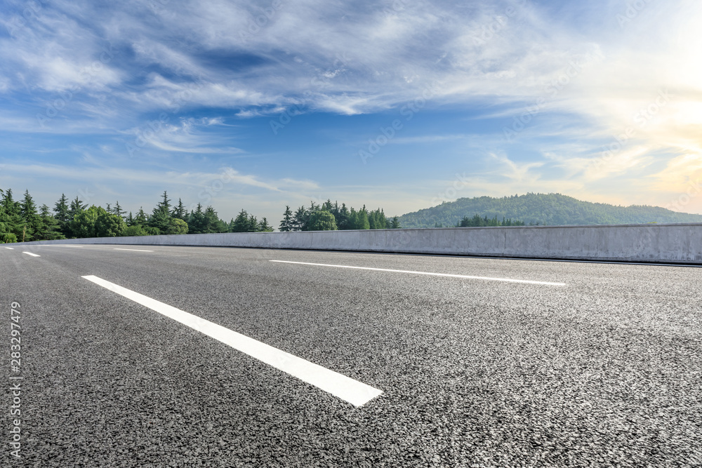 Country asphalt road and green woods nature landscape in summer Country asphalt road and green woods nature landscape in summer