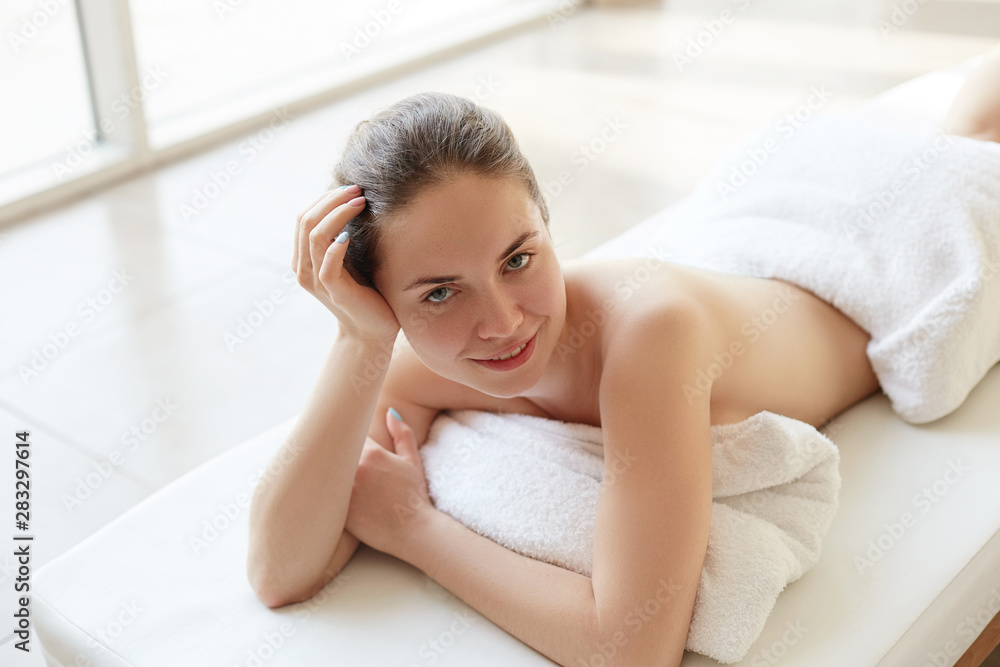 Beautiful young woman receiving massage in spa salon. Body care. Spa body massage woman hands treatment. Woman having massage in the spa salon Beautiful young woman receiving massage in spa salon. Body care. Spa body massage woman hands treatment. Woman having massage in the spa salon