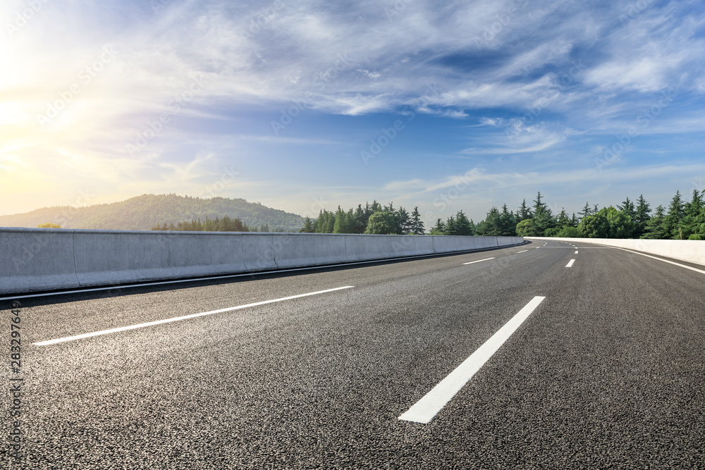 Fototapeta premium Country asphalt road and green woods nature landscape in summer