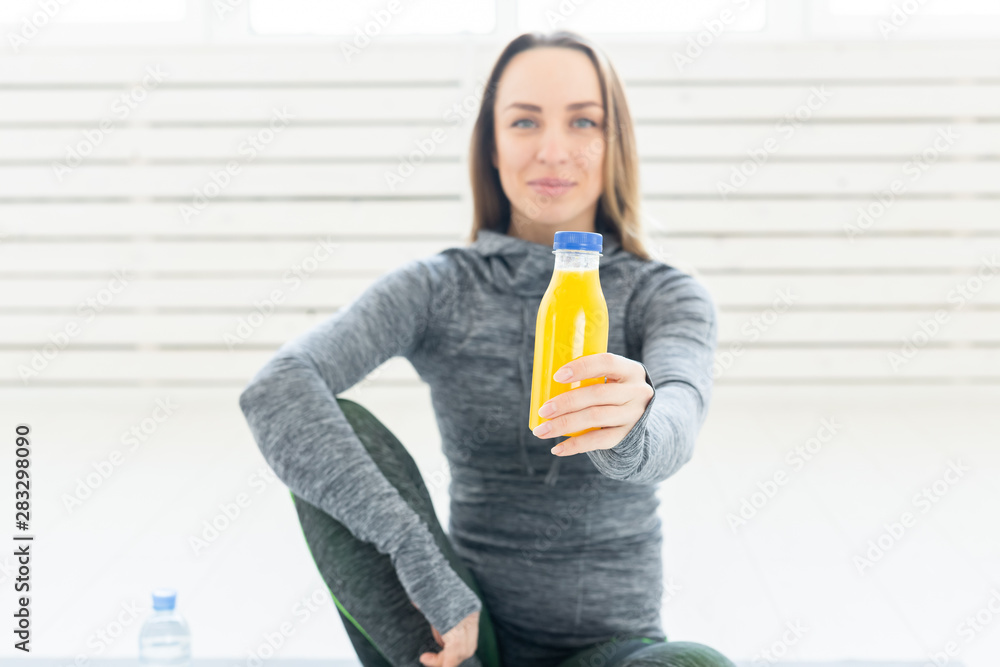 Healthy lifestyle, people and sport concept - Woman with healthy juice drinking for sport and fitness Healthy lifestyle, people and sport concept - Woman with healthy juice drinking for sport and fitness