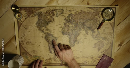 Person Deciding To Travel To Brazil On The Map Person With Magnifying Glass And UK Passport From A Birdseye View