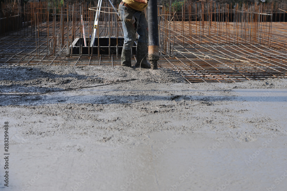 Concrete pouring during commercial concreting floors of buildings in construction Concrete pouring during commercial concreting floors of buildings in construction