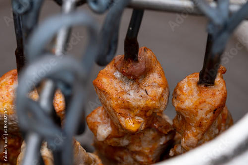 Skewers in the tandoor. Cooking kebab of meat in a tandoor. photo