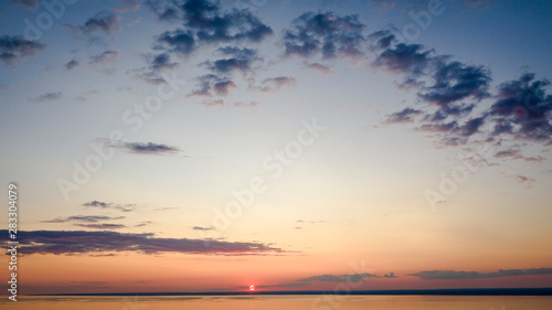 Sunset sky background. Dramatic gold sunset with evening sky clouds over the sea