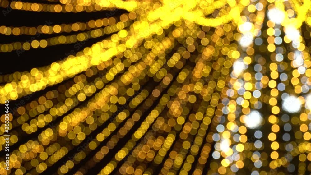 Bokeh of blurred New Year's flickering garlands. Beautiful Christmas background of warm golden lights. 4K Ultra HD Bokeh of blurred New Year's flickering garlands. Beautiful Christmas background of warm golden lights. 4K Ultra HD