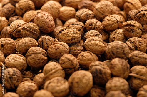 close up heap of brown walnuts. Blur background