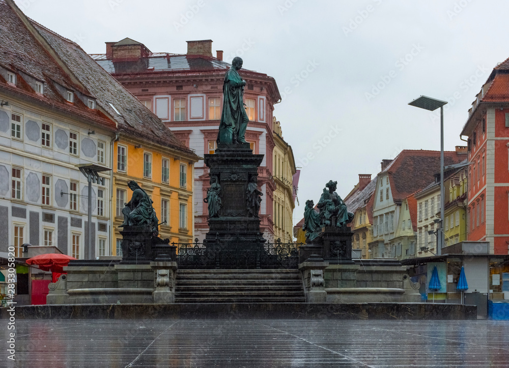 Erzherzog Johann fountain at Hauptplatz (main square) in a rainy day, in Graz, Styria region, Austria.