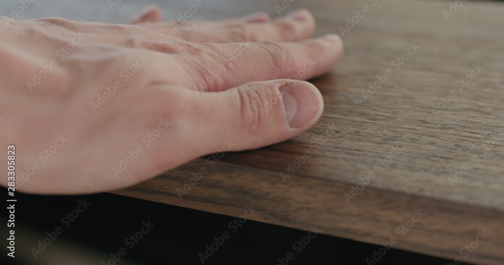 woodworker checking oil finish on black walnut woodworker checking oil finish on black walnut