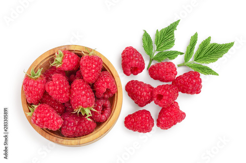 raspberries in wooden bowl with leaves isolated on white background. Top view. Flat lay