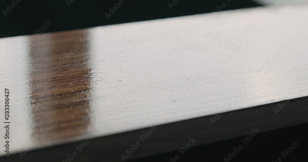 Fototapeta premium applying oil finish with brush to black walnut board