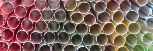 Panoramic colorful background of many drinking plastic straws