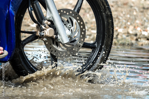 motion motorcycle rain big dirty puddle of water spray from the wheels