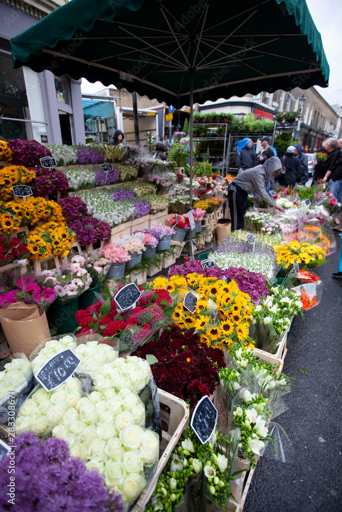 a lot of flowers for sale in the market