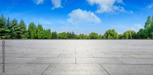 Empty square floor and green woods natural scenery in city park