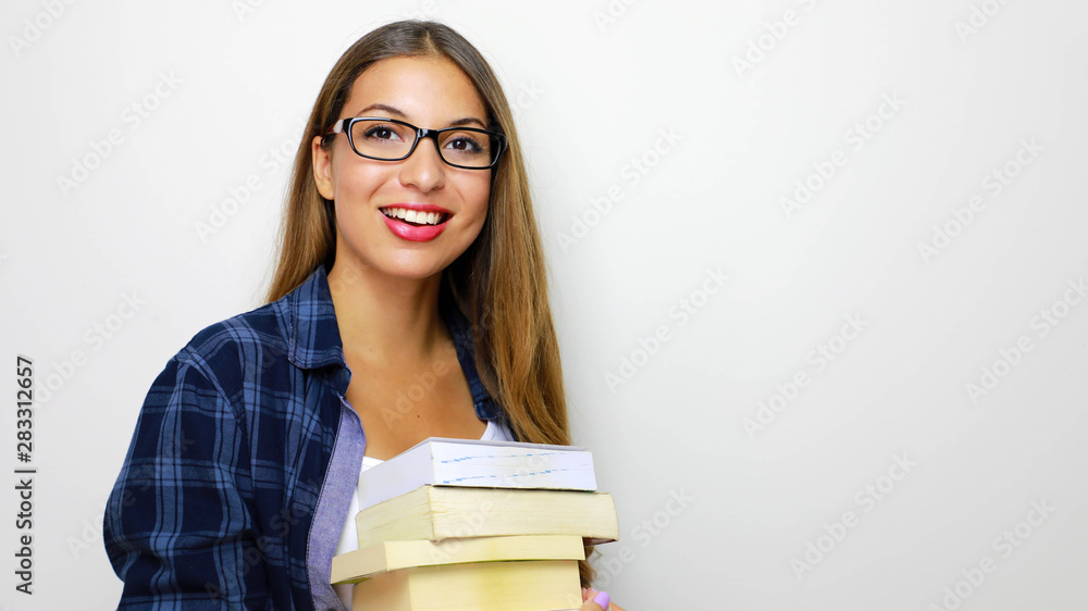Happy beautiful girl with stack of books in her hands. Studio shot on white background. Copy space. Back to school or study hard concept. Happy beautiful girl with stack of books in her hands. Studio shot on white background. Copy space. Back to school or study hard concept.