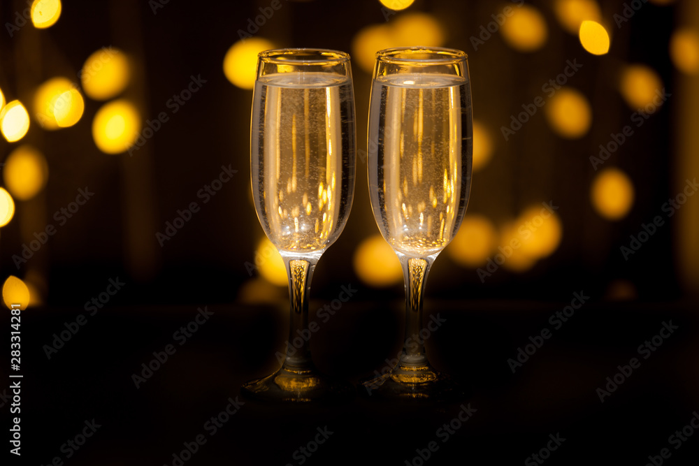 Glasses with a drink on a background of illumination Glasses with a drink on a background of illumination
