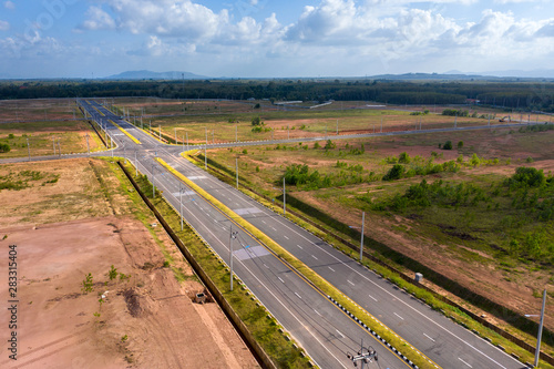 Empty crossroads and road, perpendicular to the drone from the air