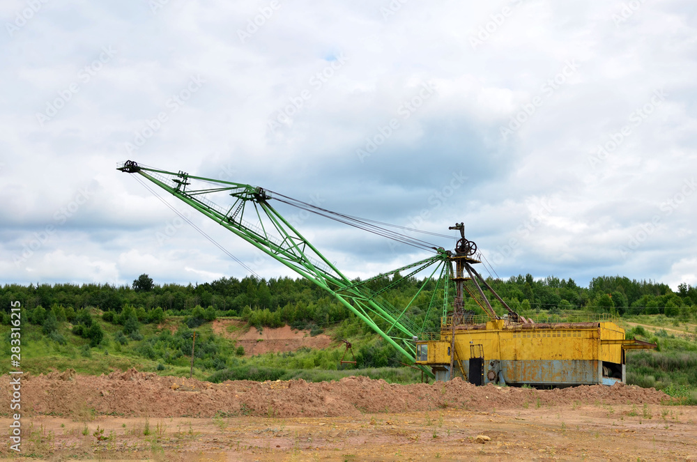 Biggest excavator dragline with a large bucket for the quarry overburden stripping. Belarus, Vitebsk, largest dolomite deposit in a open pit Biggest excavator dragline with a large bucket for the quarry overburden stripping. Belarus, Vitebsk, largest dolomite deposit in a open pit