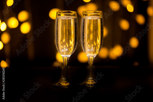 Two glasses on a background of illumination