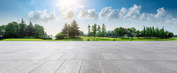Empty square floor and green woods natural scenery in city park