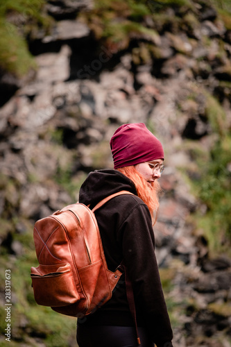 A young woman next to the waterfall at the Gorsa Bridge in the Kåfjorddalen valley