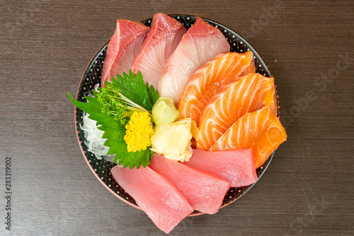 fresh salmon, tuna and hamachi on topped rice bowl (donburi) photo