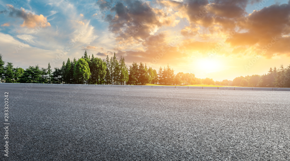 Country asphalt road and green woods nature landscape at sunset - obrazy, fototapety, plakaty 