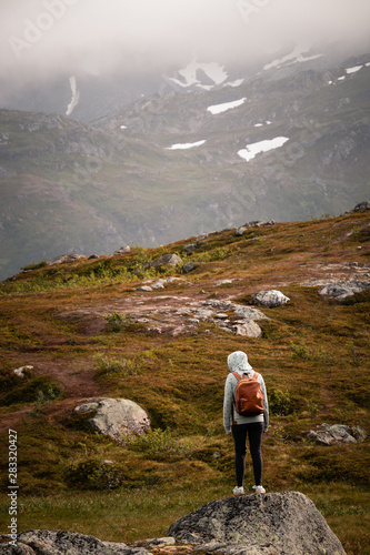 Girls hiking down to valley from a mountain in Northern Norway © Bernese Creative
