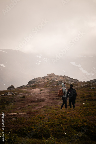 Girls hiking down to valley from a mountain in Northern Norway