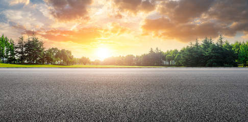 Fotobehang Cappuccinokleur Country road and green woods nature landscape at sunset  © ABCDstock