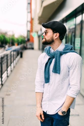 Fashionable handsome young man in urban street background