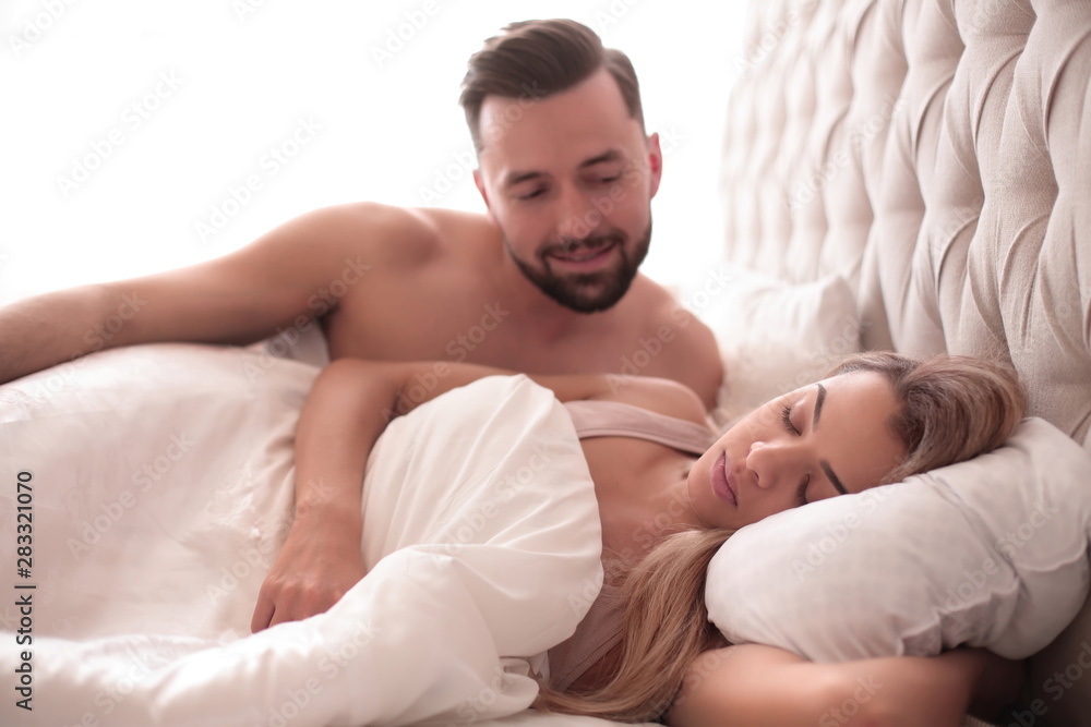 loving man looking at his sleeping wife loving man looking at his sleeping wife
