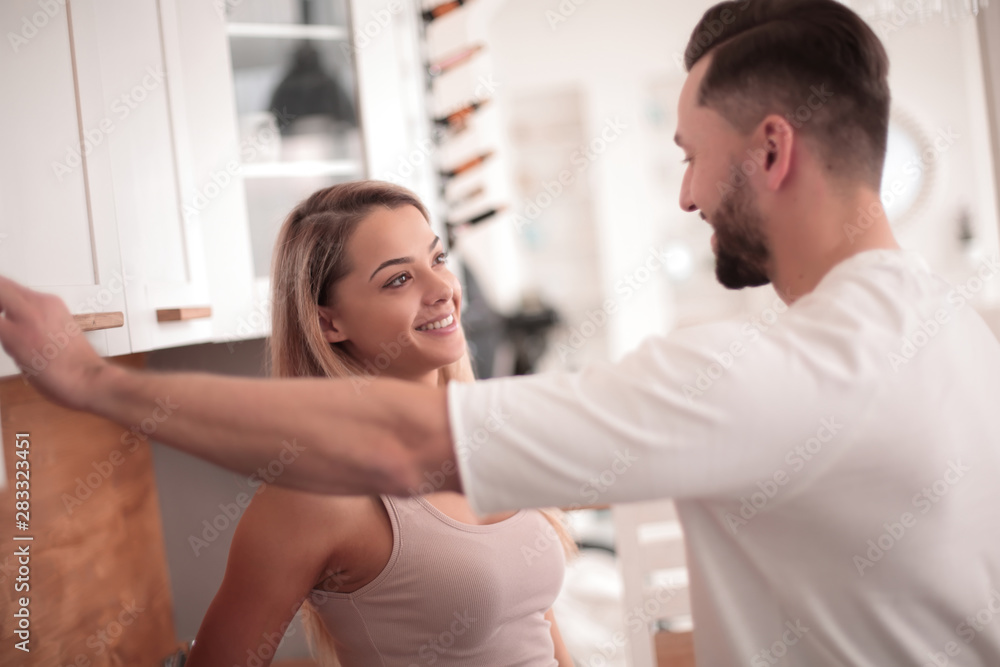 Fototapeta premium close up. a married couple talking standing in their kitchen.
