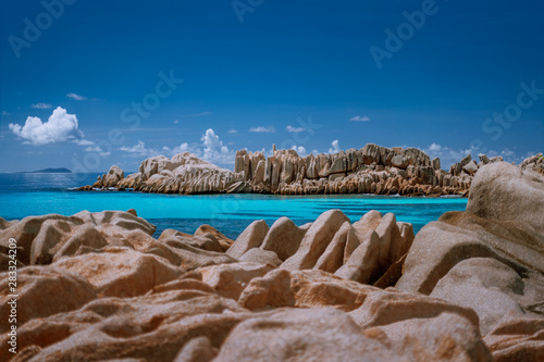 Seychelles La Digue. Scenery of amazing huge shaped granite rocks stones and blue turquoise ocean lagoon