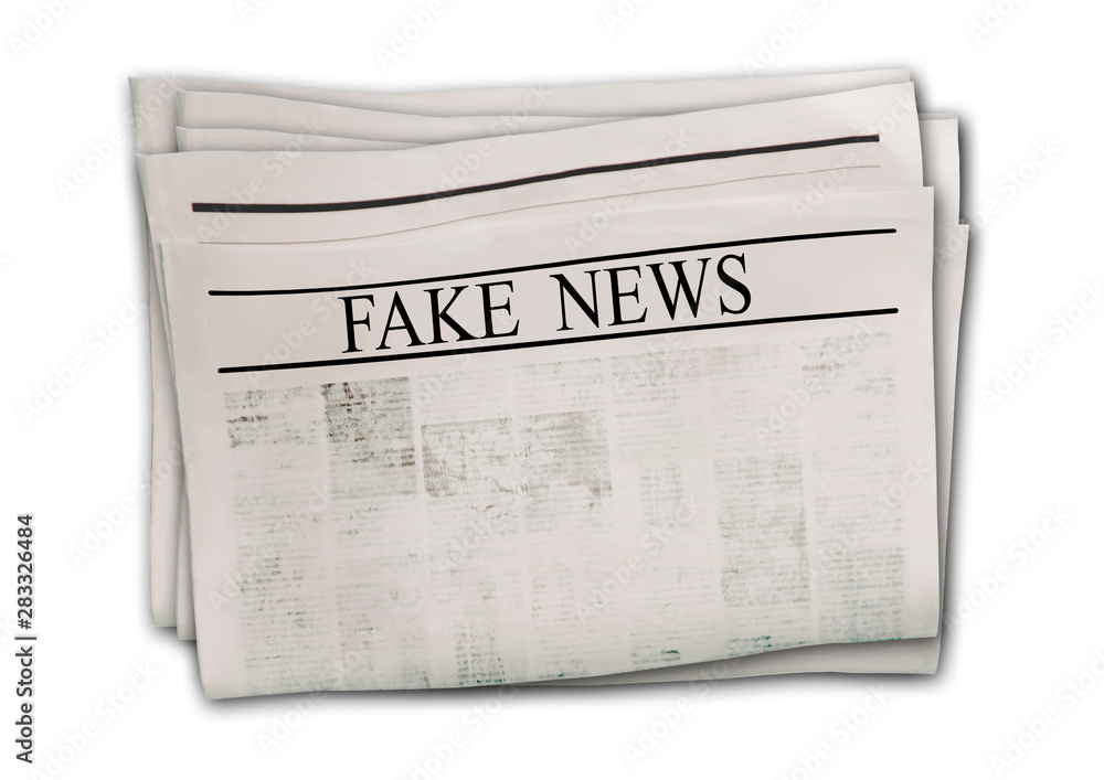 Fototapeta premium Newspaper with headline Fake News isolated on white background.