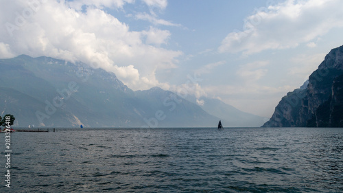 Sailboat on Lake Garda with mountain background