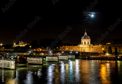 Institut de France and people walking on Pont des Arts at night - Paris, France. © UlyssePixel