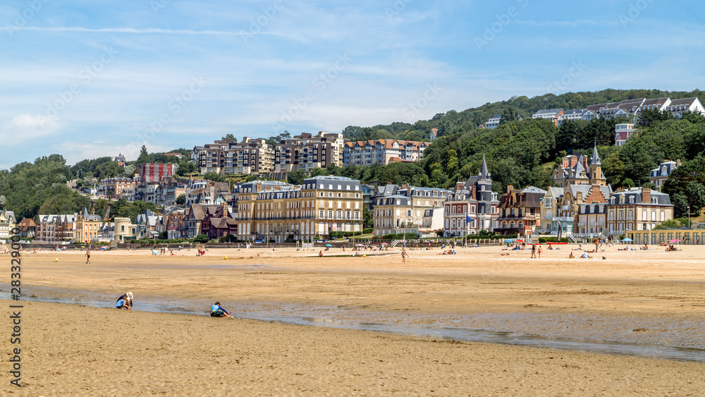 Panoramic view of the beach of Trouville and beautiful luxury buildings along the beach at low tide. Famous resort and fishermen village in Normandy, France. Panoramic view of the beach of Trouville and beautiful luxury buildings along the beach at low tide. Famous resort and fishermen village in Normandy, France.