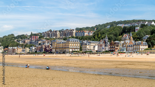 Panoramic view of the beach of Trouville and beautiful luxury buildings along the beach at low tide. Famous resort and fishermen village in Normandy, France.  © Telly