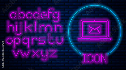 Glowing neon Laptop with envelope and open email on screen icon isolated on brick wall background. Email marketing, internet advertising concepts. Neon light alphabet. Vector Illustration
