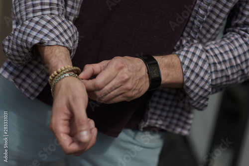 straightens the bracelet with his hand © vladimirkolens