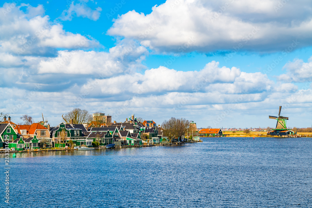 Tradition Dutch Houses in Saandijk with the River Zaan and a wooden windmill