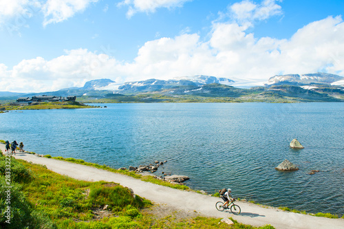 Tourists hiking and tourist biking in Finse, Norway on July 2019  photo