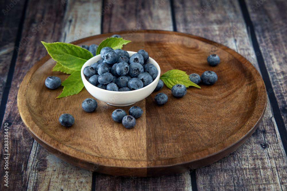 Black currant fresh ripe currant berries on a old vintage wooden table with green leaves. Juicy natural fruits currant. Black currant fresh ripe currant berries on a old vintage wooden table with green leaves. Juicy natural fruits currant.
