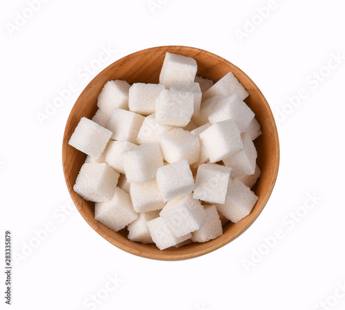 Top view of white pure sugar cubes in wooden bowl isolated on white background