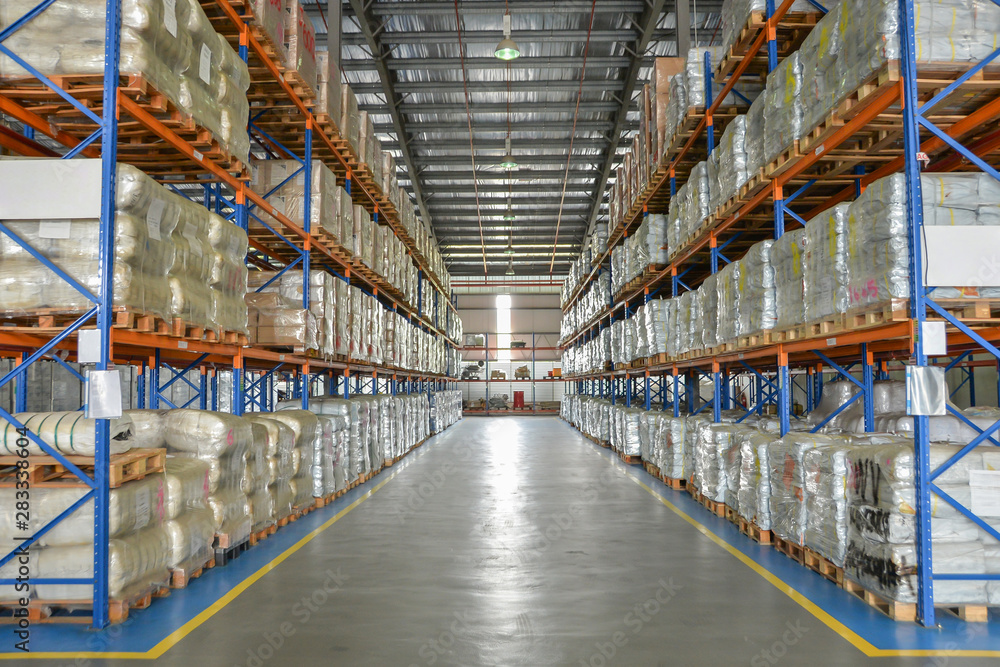 Logistic cargo warehouse with shelves of package on pallet.