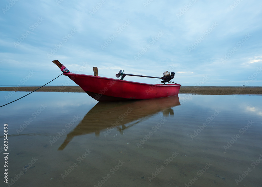 A red fisherman boat on the beach